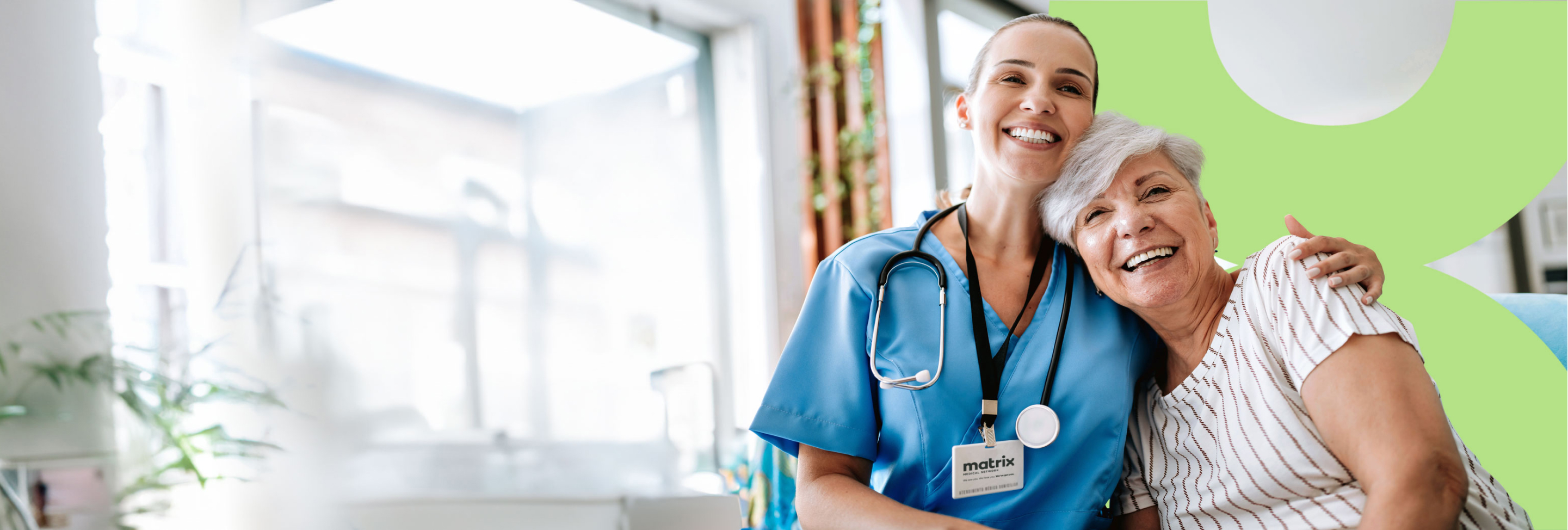 Nurse and patient embracing each other smiling