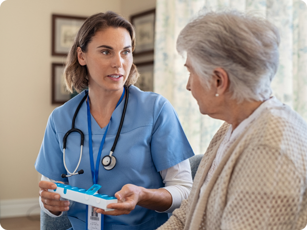 nurse showing her patient what medications she needs to take this week