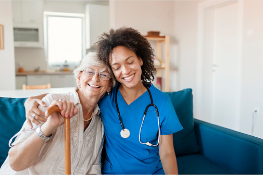 Nurse and patient embracing each other smiling on the couch